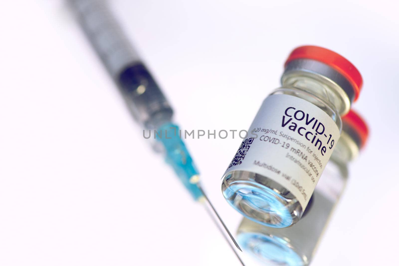 Ampoules with COVID-19 coronavirus vaccine, with a syringe for vaccination. Healthcare And Medical concept.