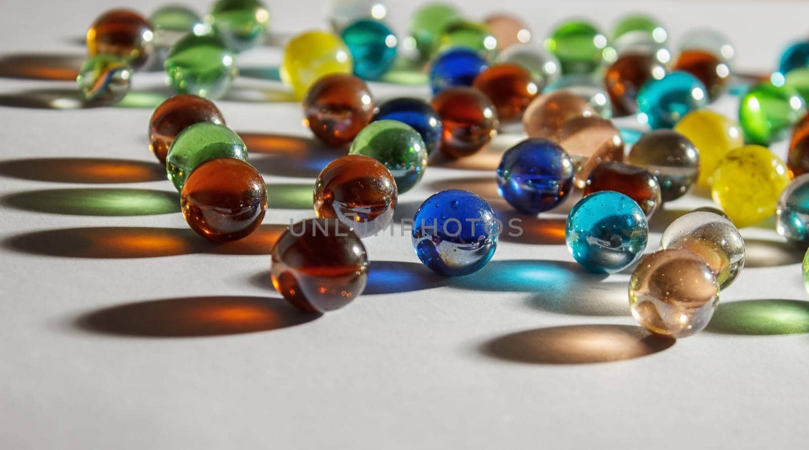 multicolored glass balls on the table indoor closeup