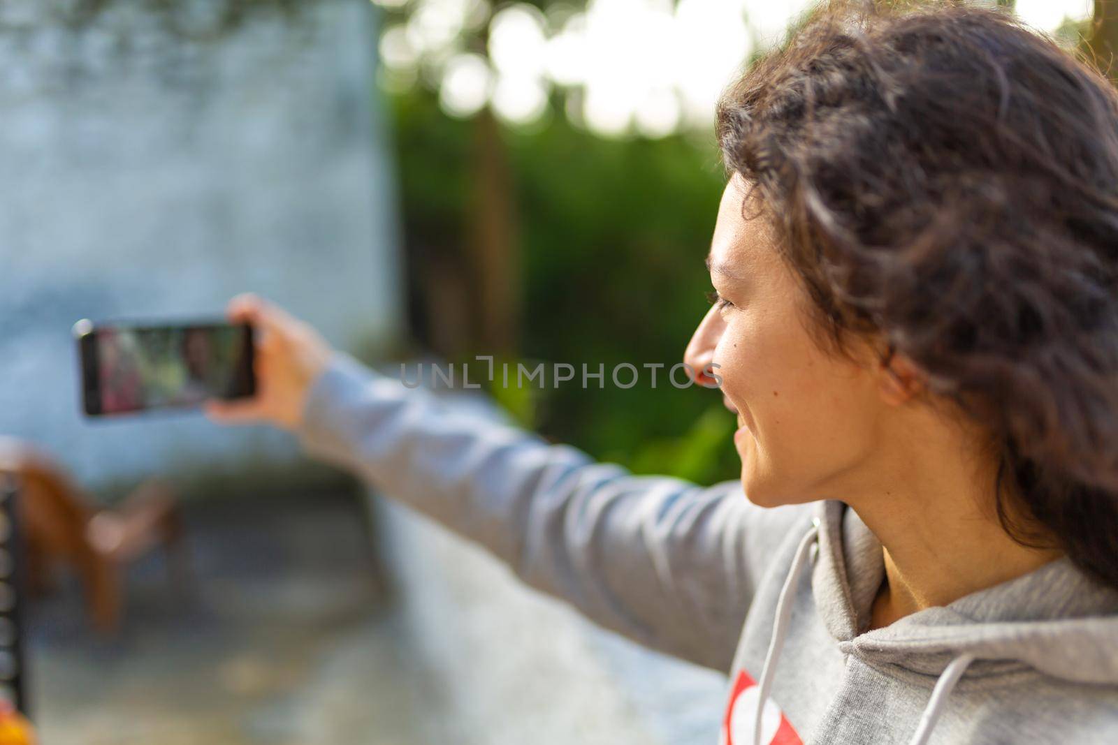A young girl blogger takes pictures of herself with a phone. Blogger's video report.