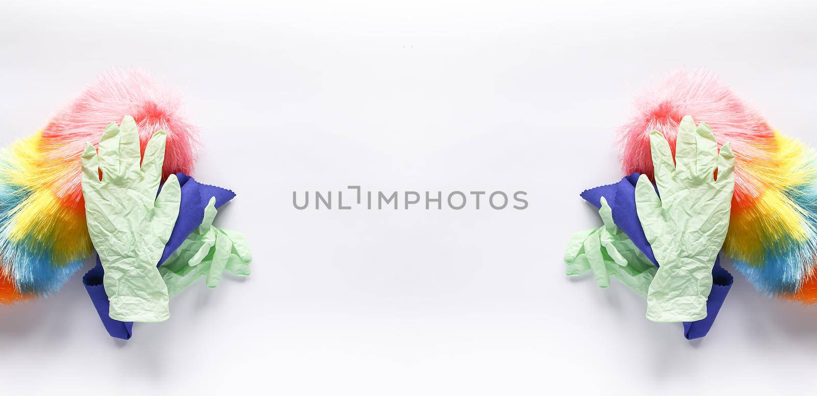Rubber gloves, the duster and microfiber cloth on light background. Symmetrical long banner