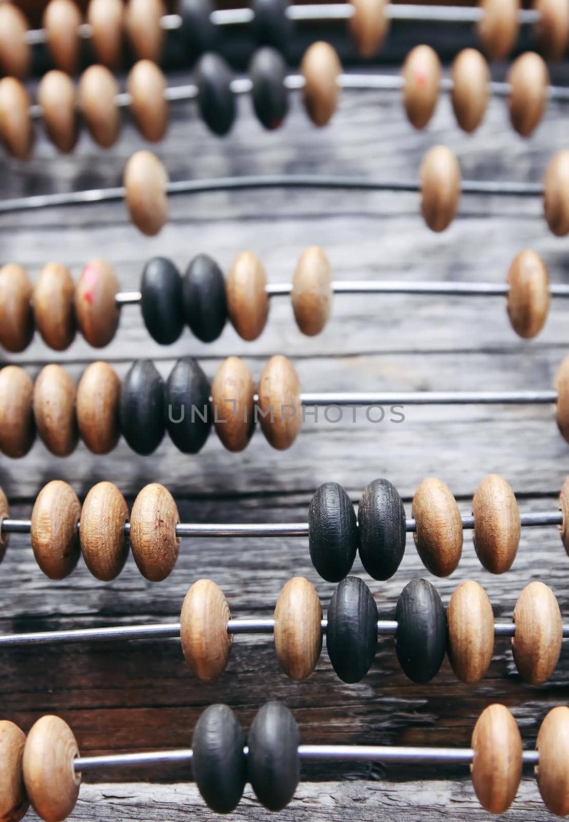 Vintage wooden abacus on old board surface.