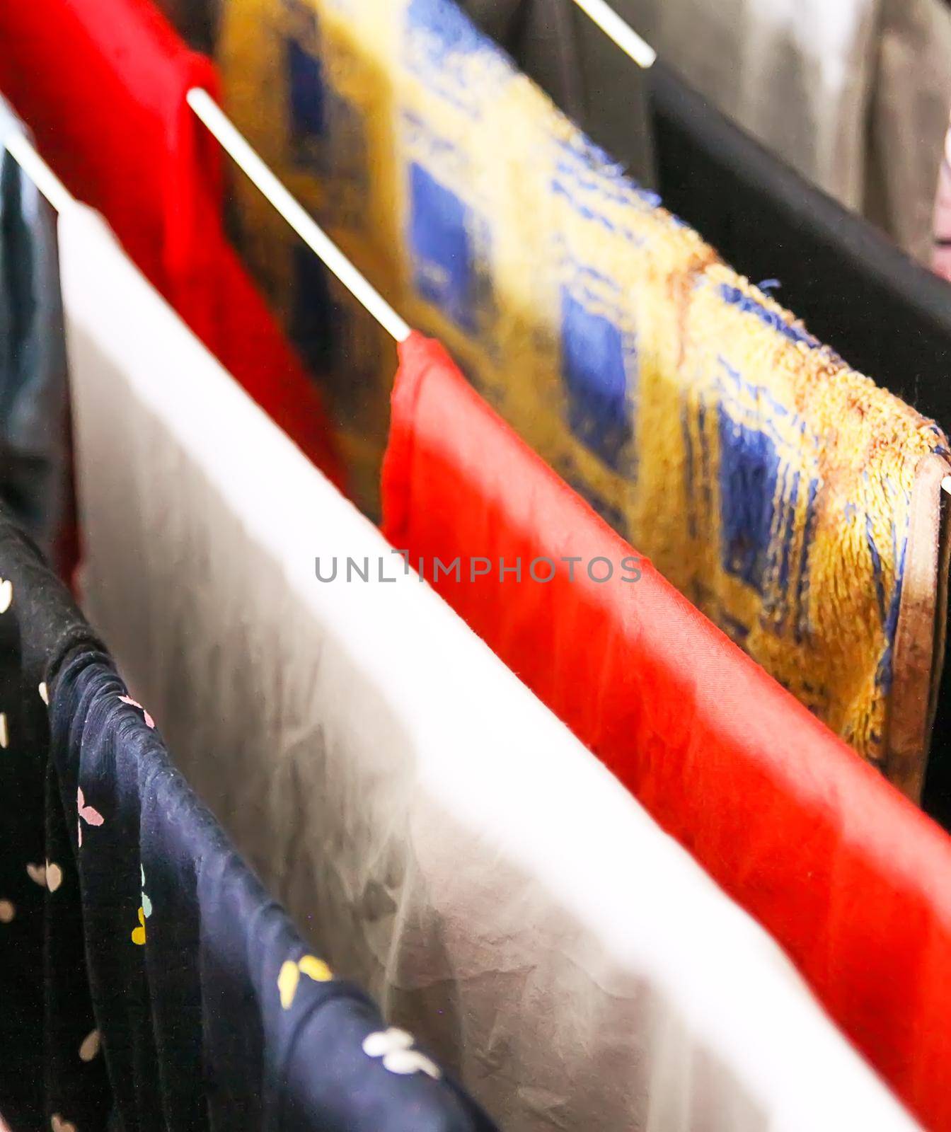 Colorful different dress and laundry hanging on a drying rack.