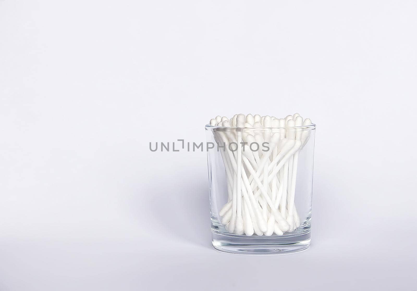 Cotton swabs or ear sticks in glass storage.