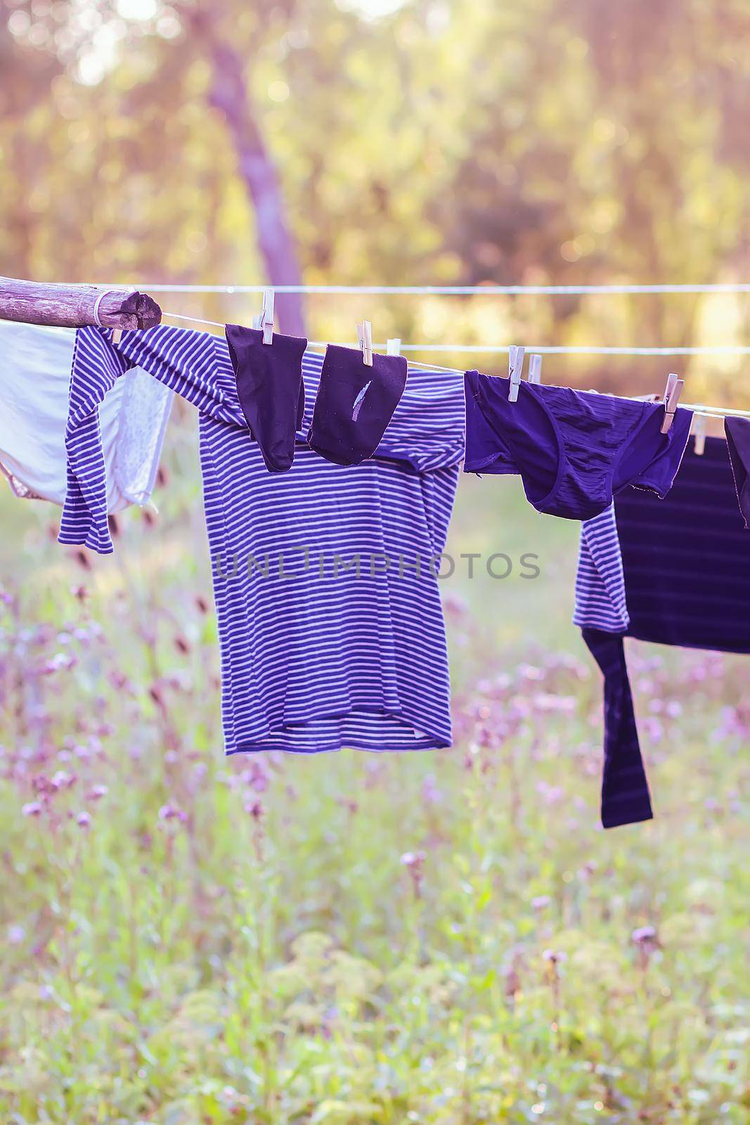 Washed colorful clothes hanging on a clothesline outdoors