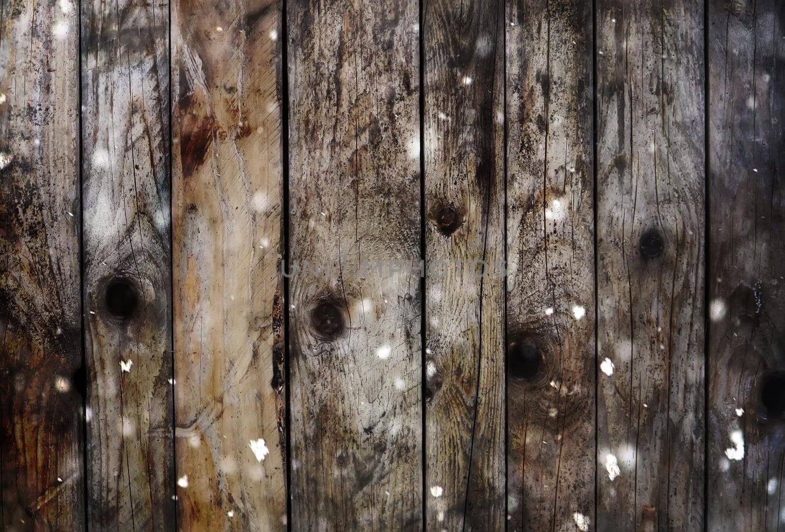 Background of dark wooden boards with fluffy snow effect.