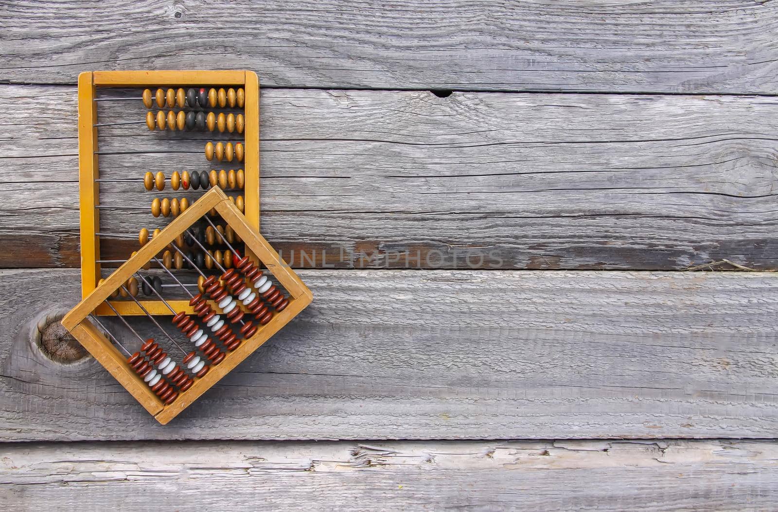 Vintage wooden abacus on old board surface.