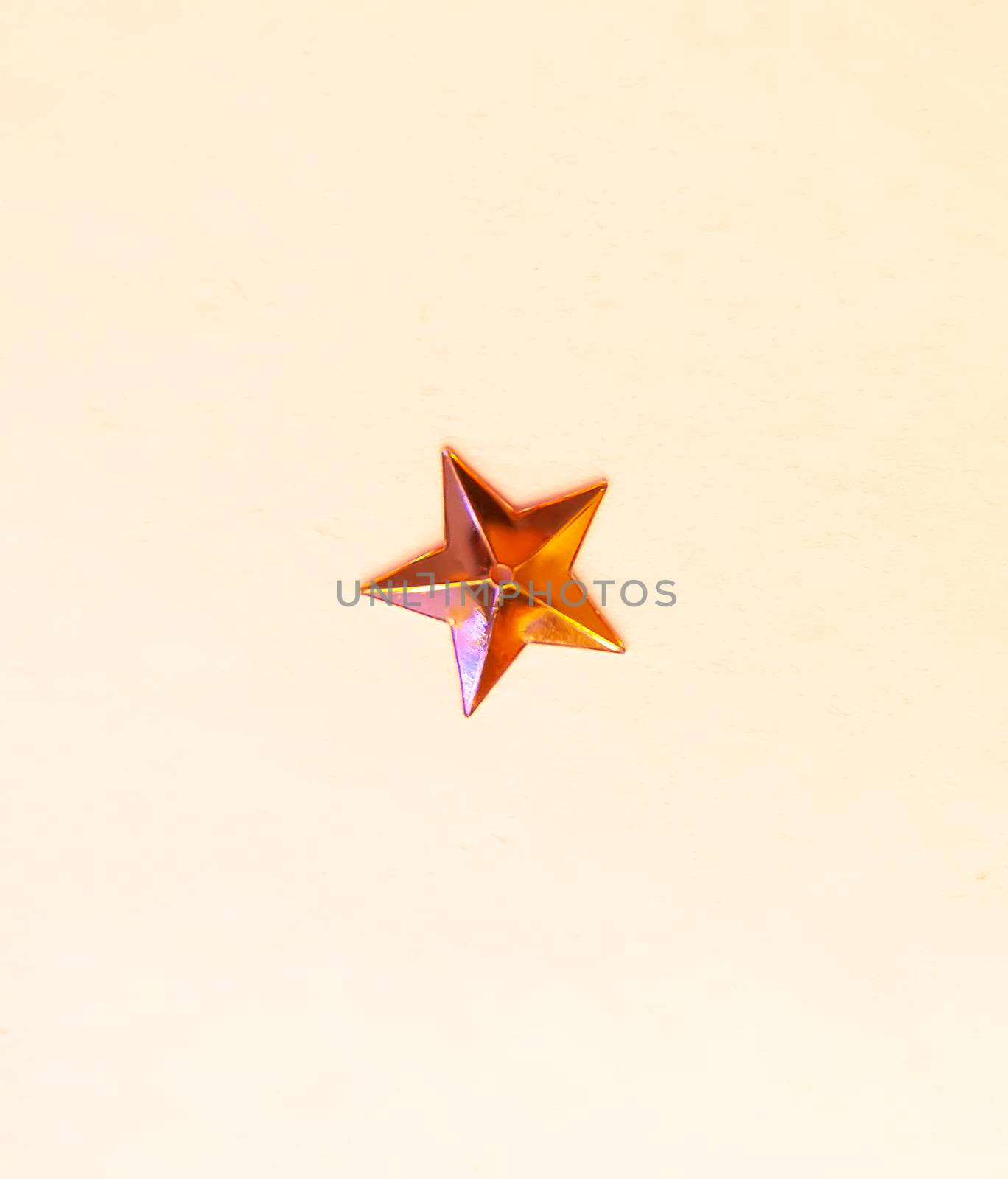 Single olden star confetti on white background