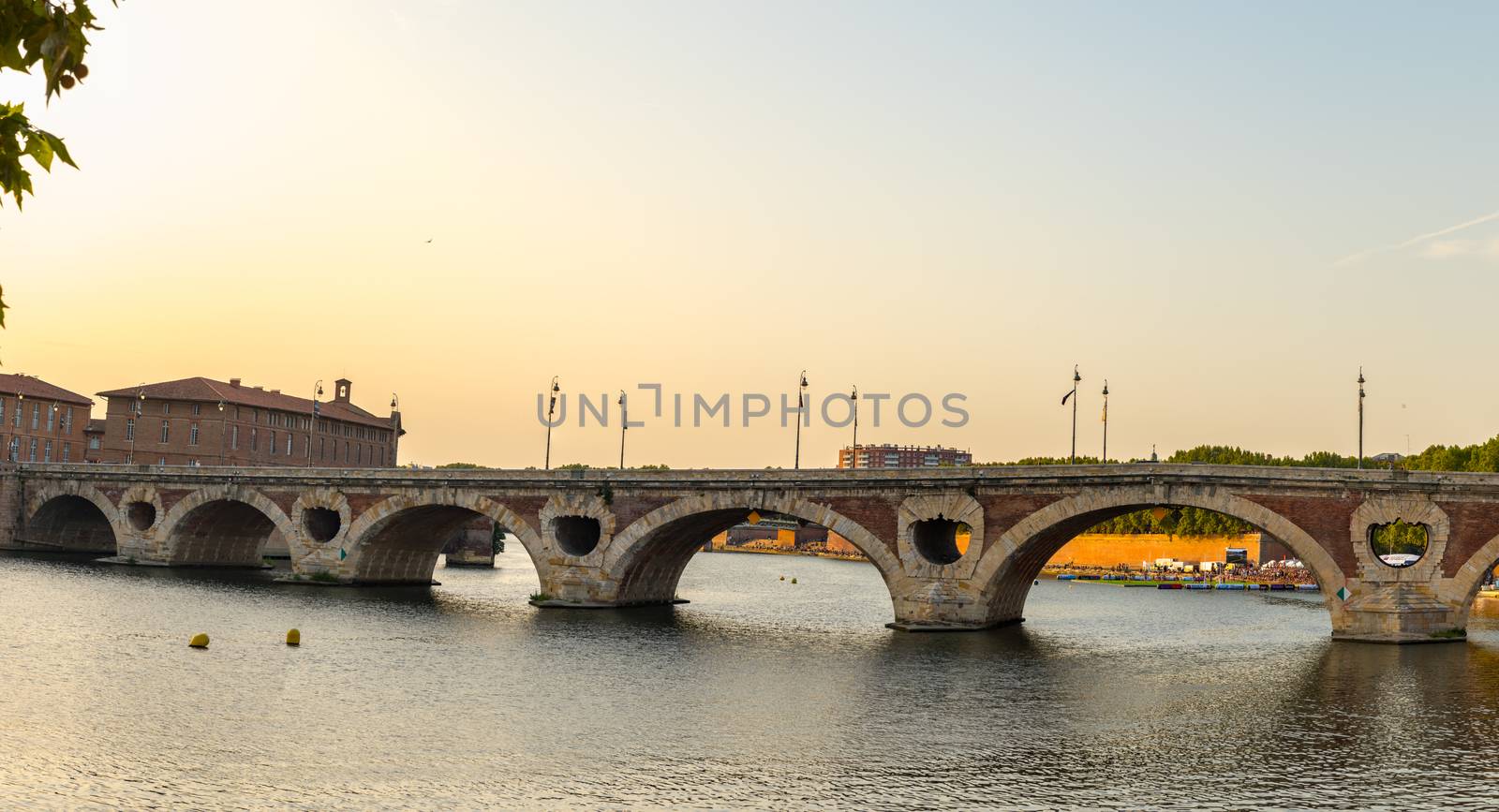 Sunset in the Garonne river and its bridges in Toulouse in Haute-Garonne, Occitania, France.