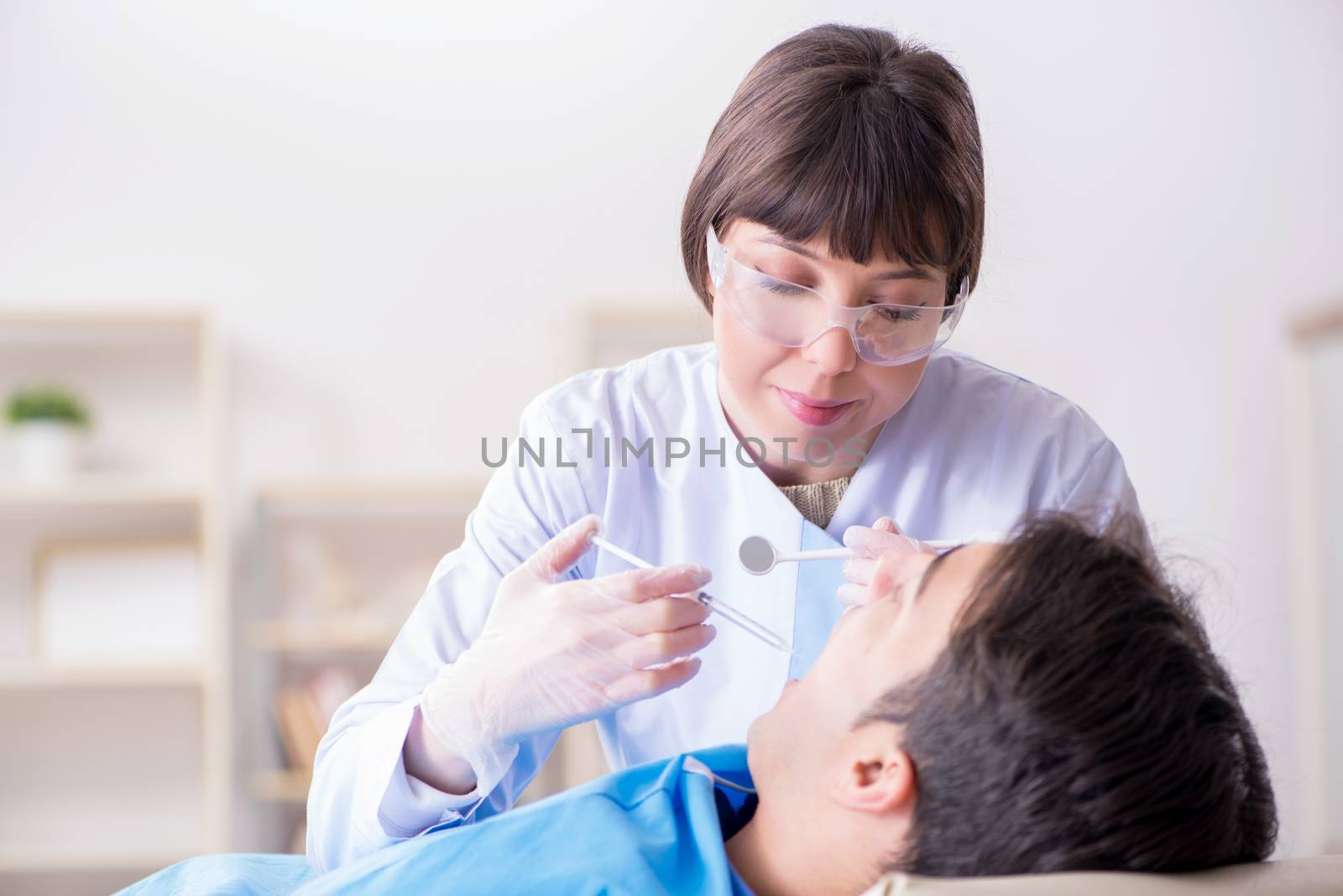 Patient visiting dentist for regular check-up and filling by Elnur