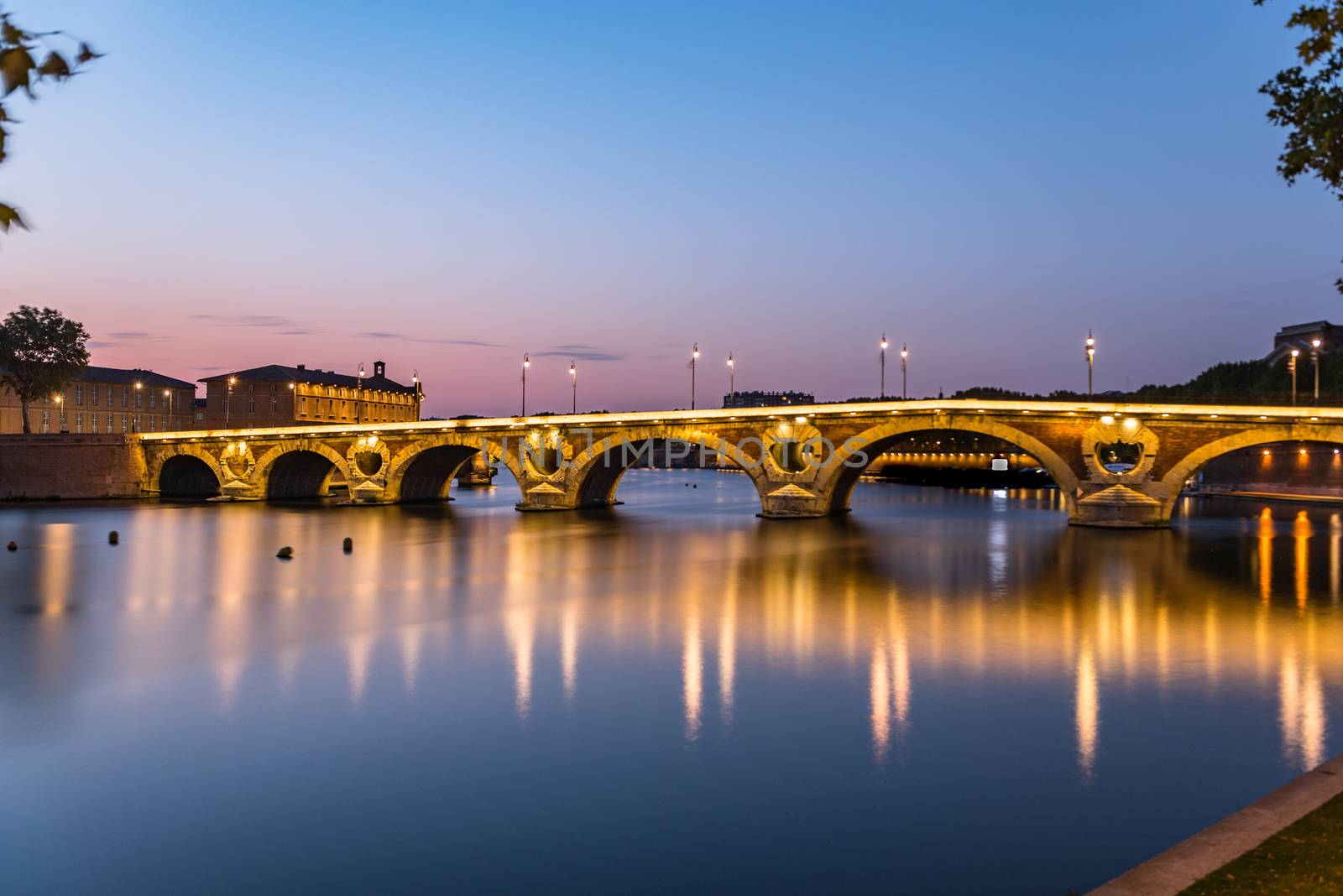 Sunset in the Garonne river and its bridges in Toulouse in Haute-Garonne, Occitania, France.