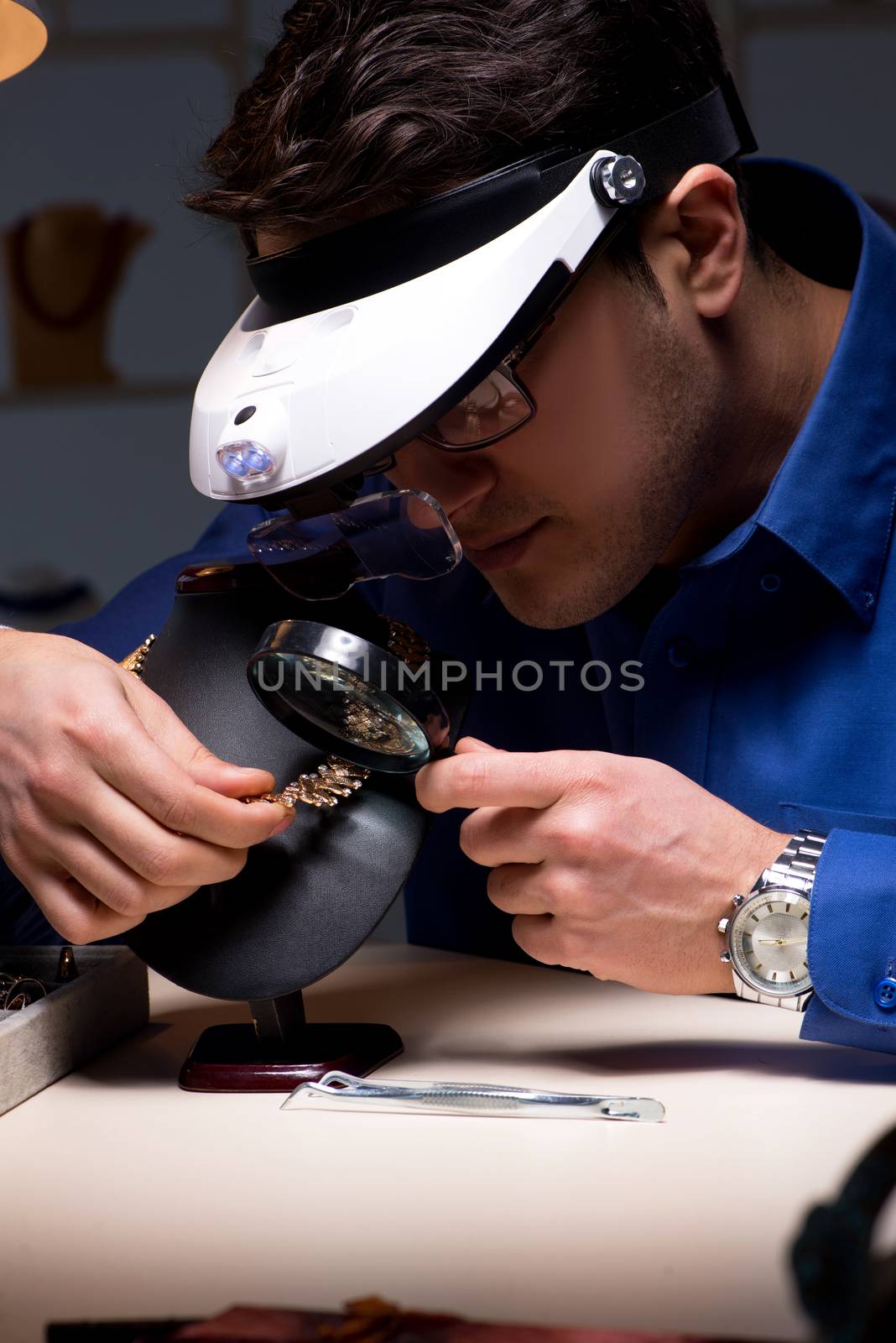 Jeweler working in his workshop late at night