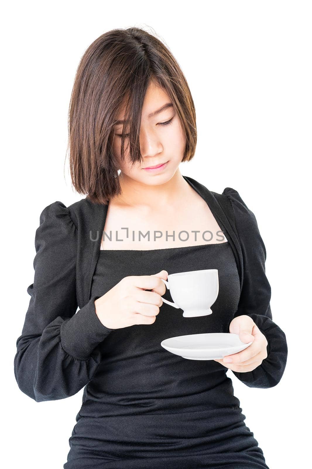 Young woman sittng holding coffee cup on white background