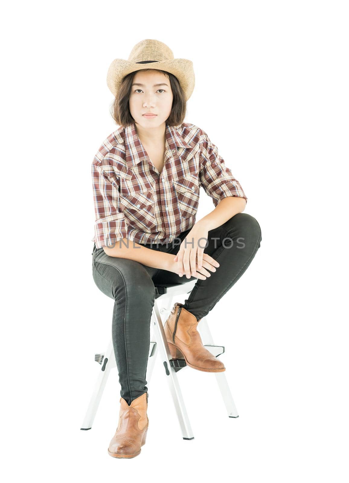 Young woman in a plaid shirt posing in studio on white background by stoonn