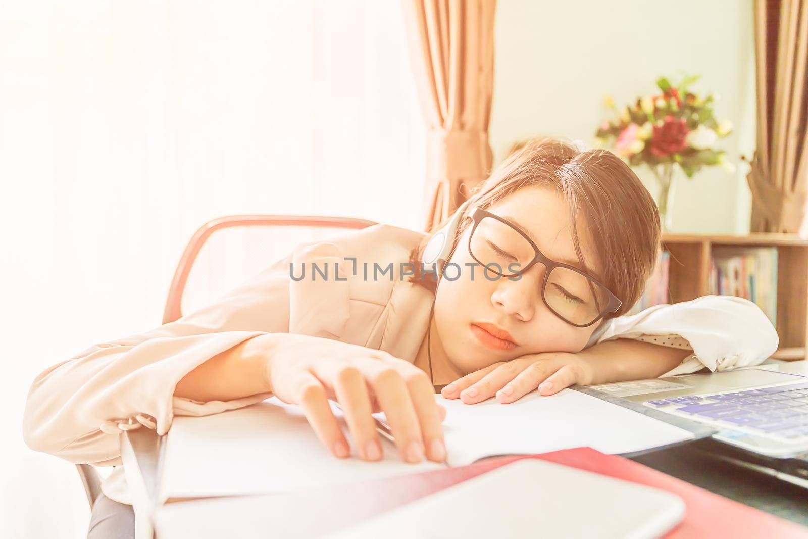 Teenage girl short hair relaxed after working on laptop while sit near window at home office