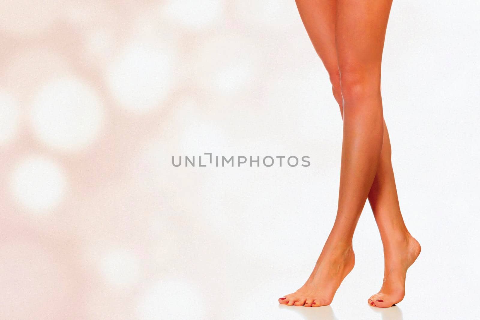 Legs of a woman against abstract background with circles and copyspace by Nobilior