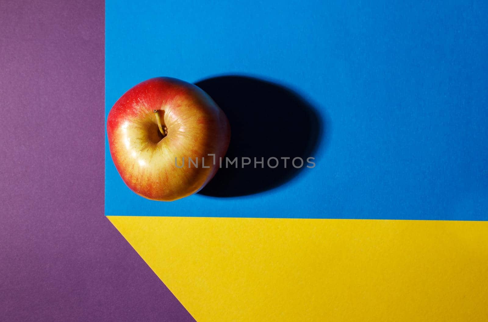 ripe red applel on the colored table by raddnatt