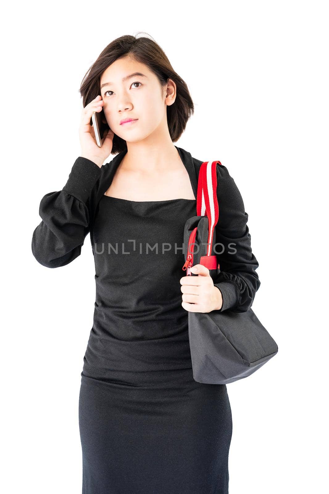 Woman carrying a black shopping bag using cellphone shopping online isolate on white background