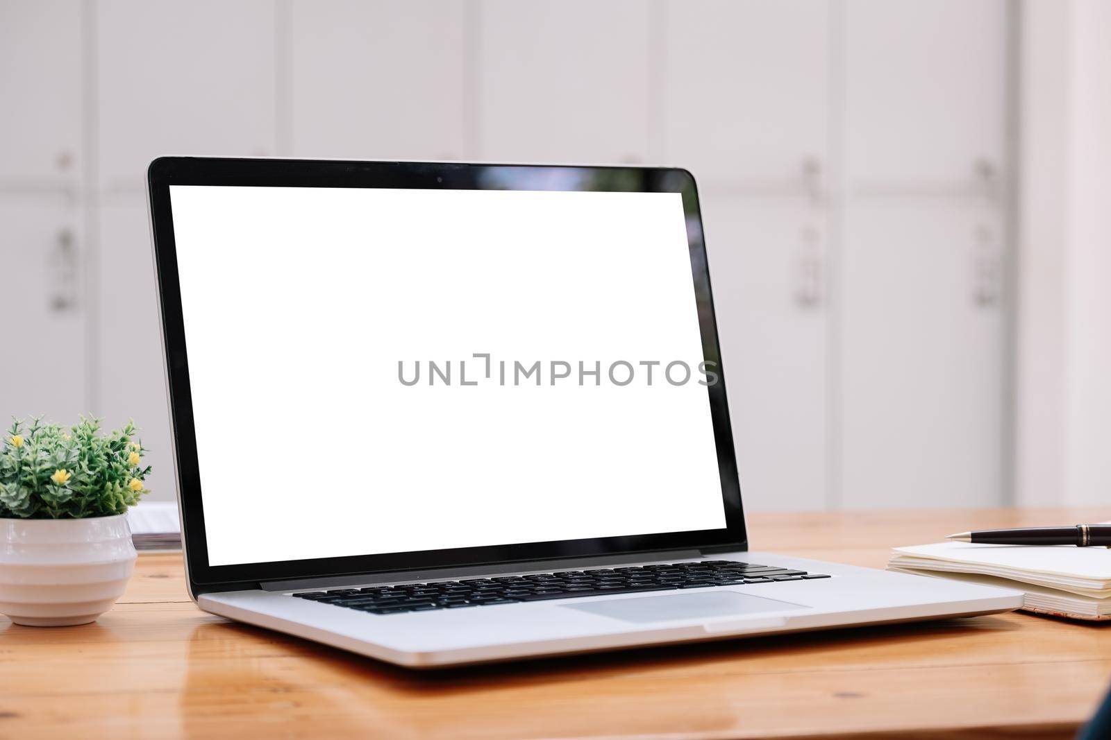 Laptop blank white screen on wood table at cafe shop, mockup, template for your text. by nateemee