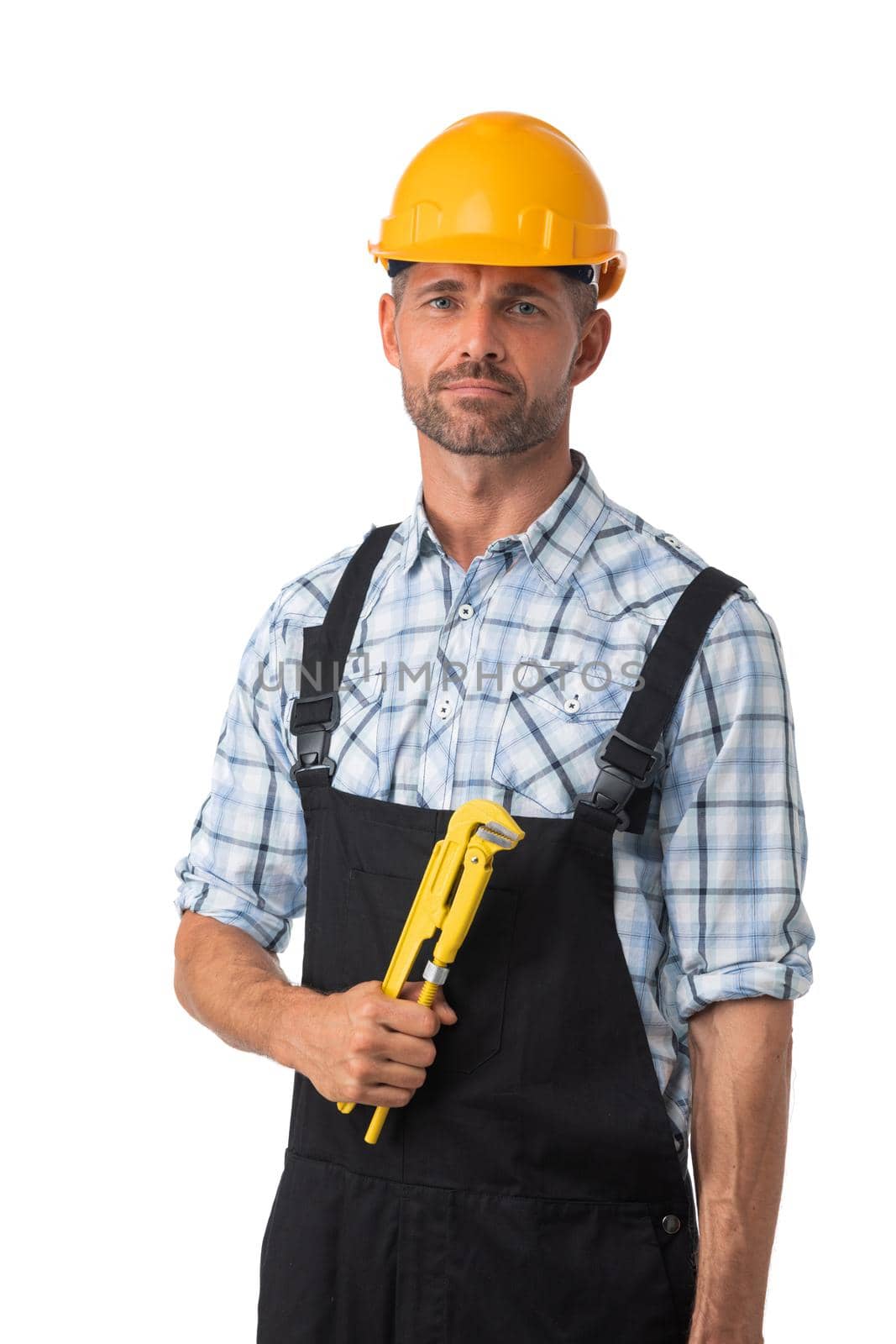 Portrait of confident male repairman contractor worker in coveralls holding adjustable spanner isolated on white background
