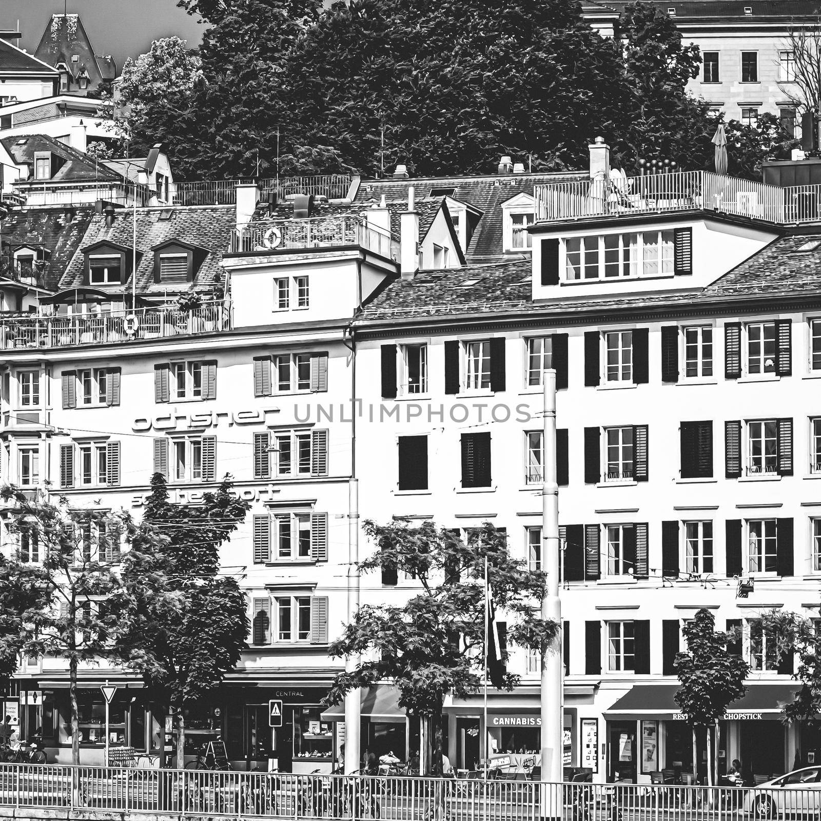 Zurich, Switzerland circa June 2021: Vintage monochrome view of historic Old Town streets and buildings near main train station Zurich HB, Hauptbahnhof, Swiss architecture and travel destination