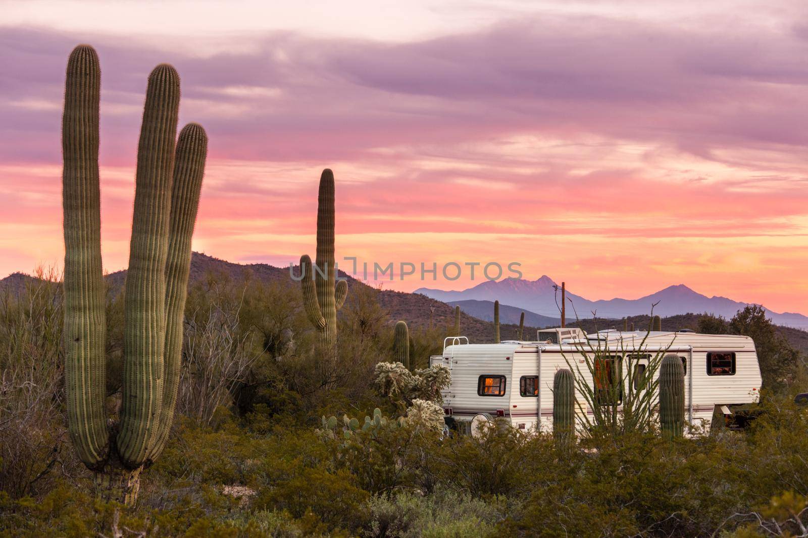 Fifth wheel camping trailer on desert campground by PiLens