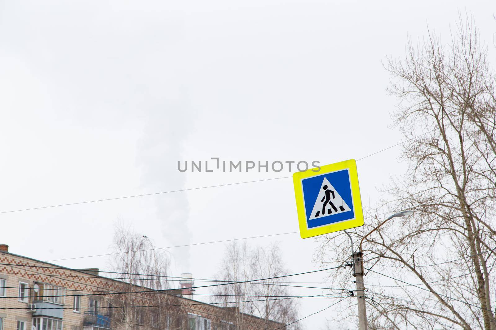 A pedestrian crossing road sign hangs over the carriageway.  by anarni33