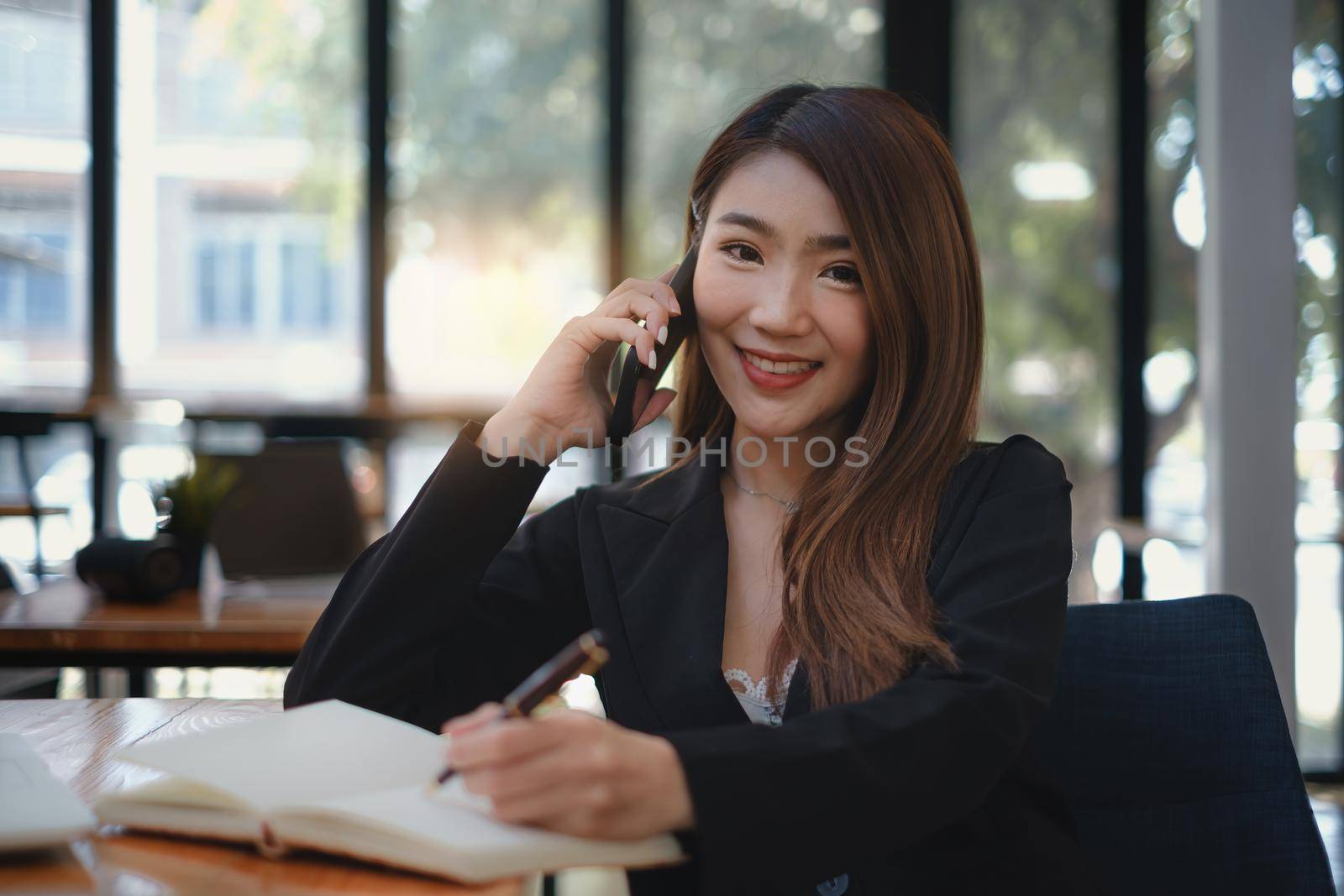 A successful organization as a manager is represented by a happy entrepreneur. Businesswoman talking with her exculsive customer. by itchaznong