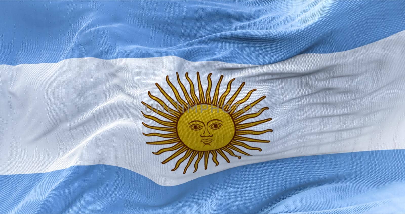 Close-up view of the national flag of Argentina waving in the wind. Horizontal striped flag in light blue color and the May Sun in the center. South American state. Democracy and independence.