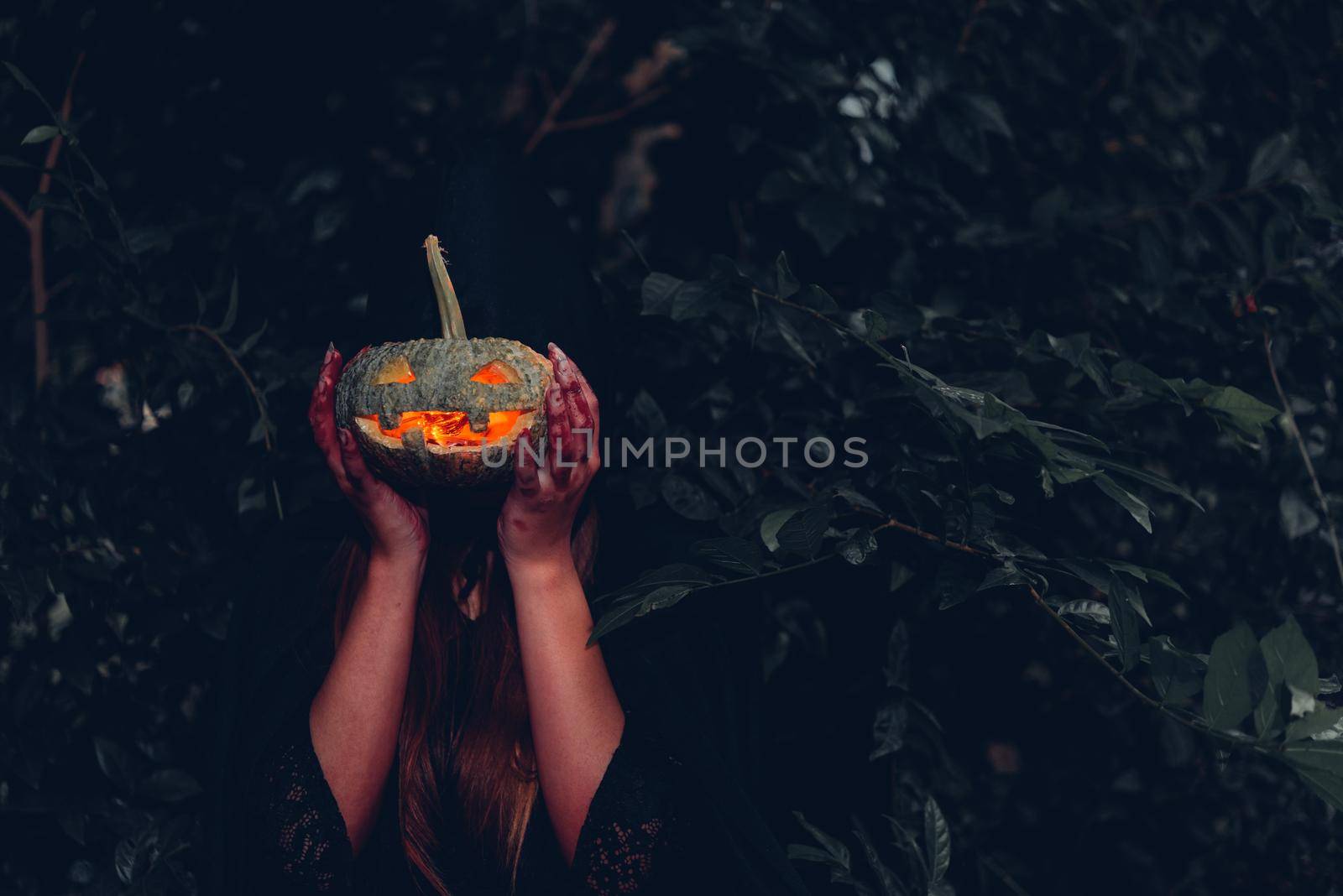 Portrait woman scary ghost in forest he has holding pumpkin  by Sorapop
