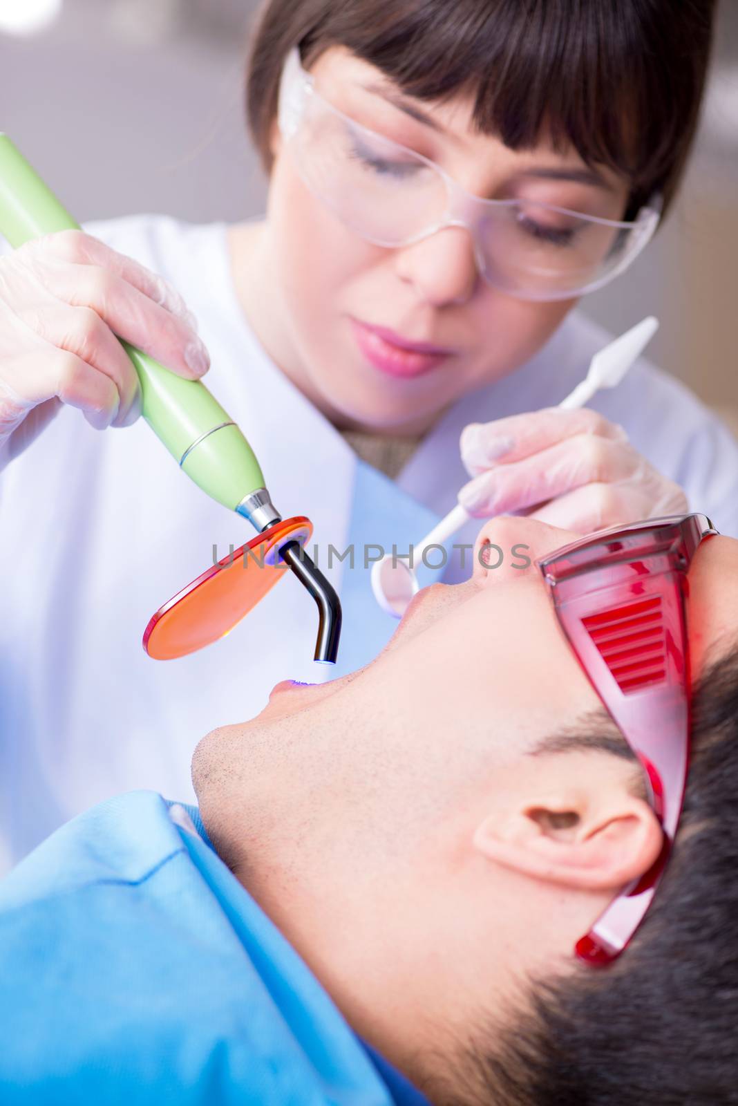 Patient visiting dentist for regular check-up and filling by Elnur