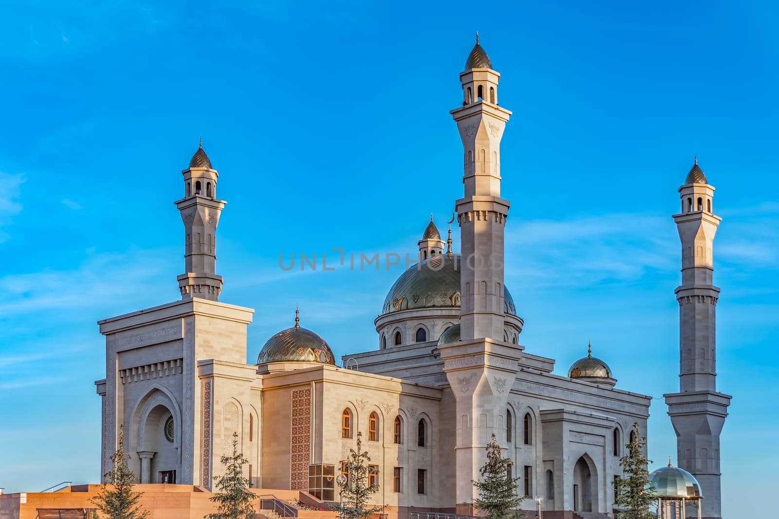 A Muslim Islamic mosque with golden minarets and a crescent moon against the sky.A religious temple for praying and worshipping the God of Muslims in Islamic culture and belief in Allah. by YevgeniySam