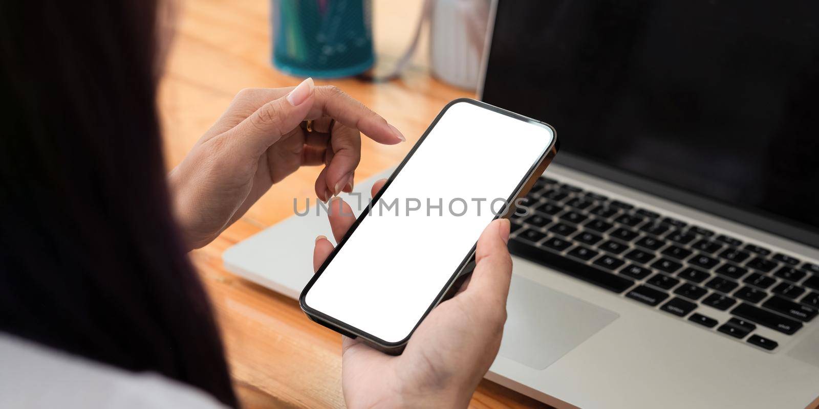 Close up of woman using mobile smart phone with blank white screen, Phone with black screen mockup. by nateemee