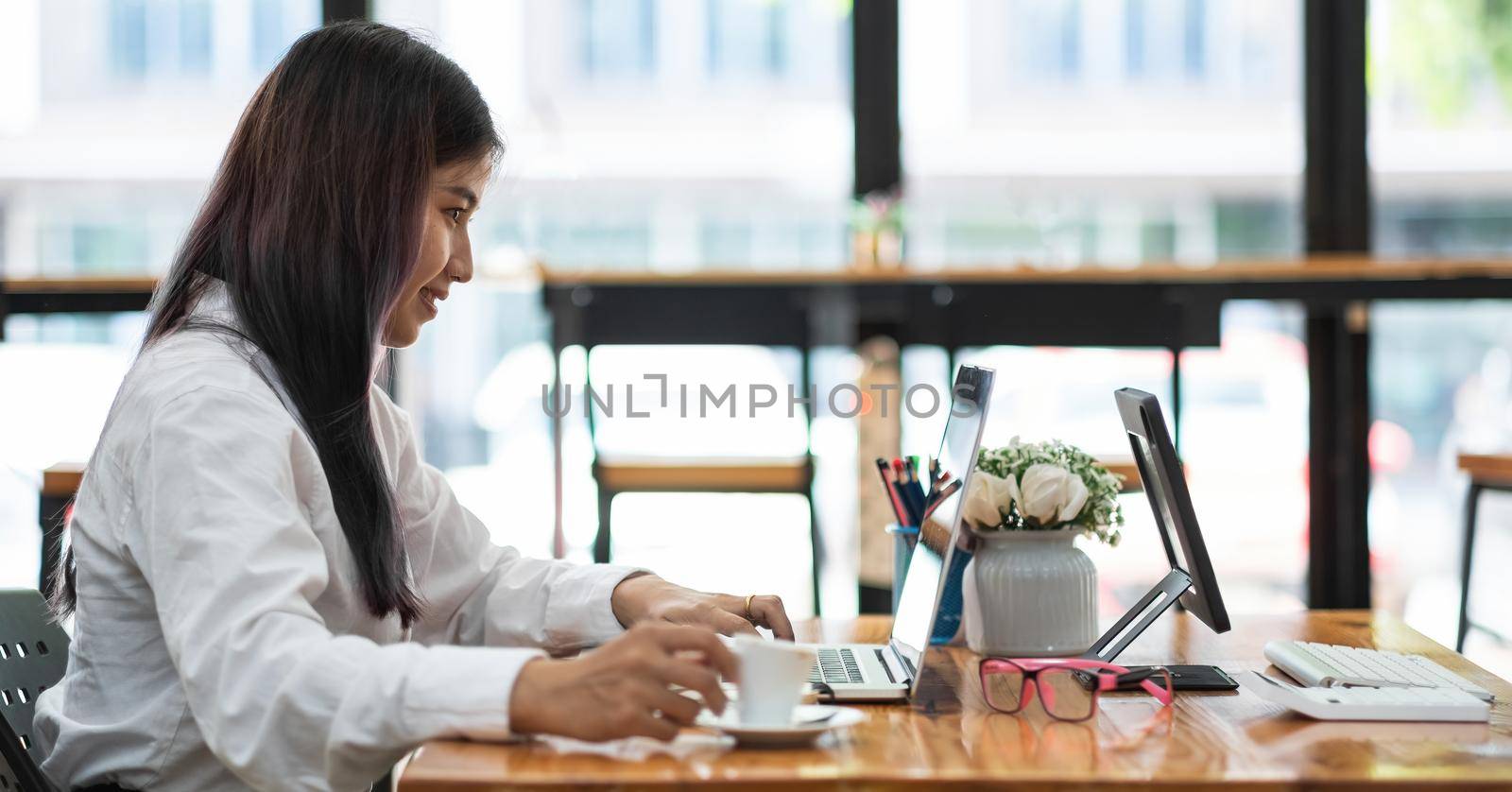 businesswoman or accountant hand using laptop computer with financial data report, accountancy document and calculate at office, business concept