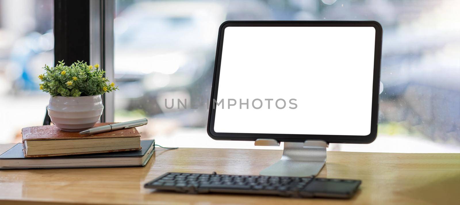 Blank screen Laptop computer and poster workspace background in modern office by wichayada