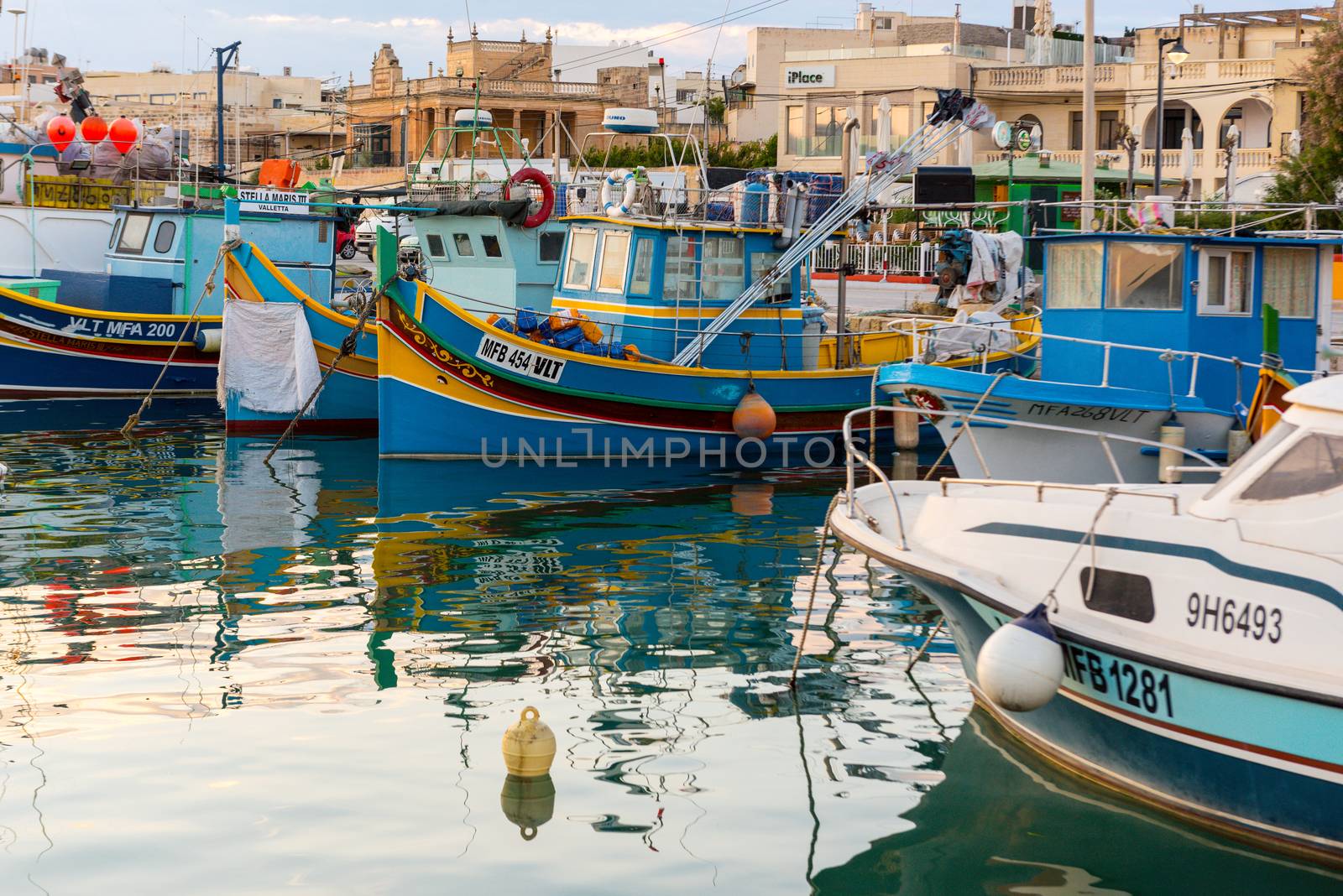 Traditional eyed colorful boats Luzzu in the Harbor of Mediterranean fishing village Marsaxlokk, Malta