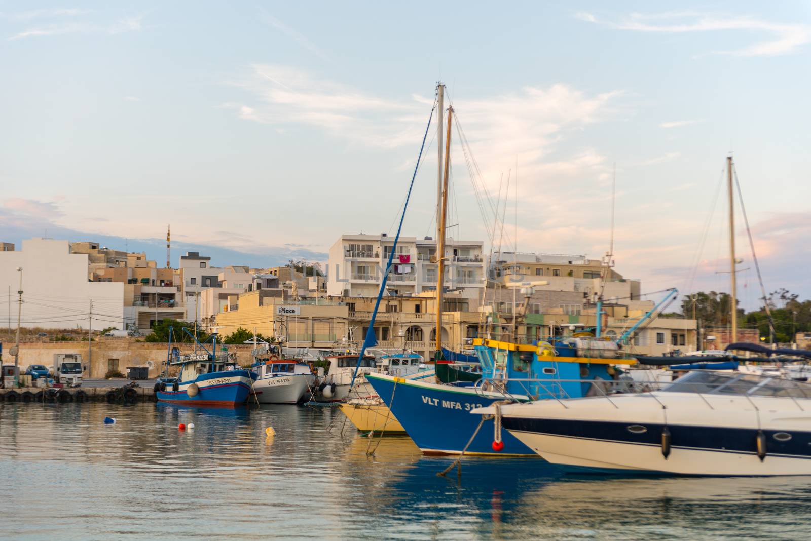 Traditional eyed colorful boats Luzzu in the Harbor of Mediterranean fishing village Marsaxlokk, Malta