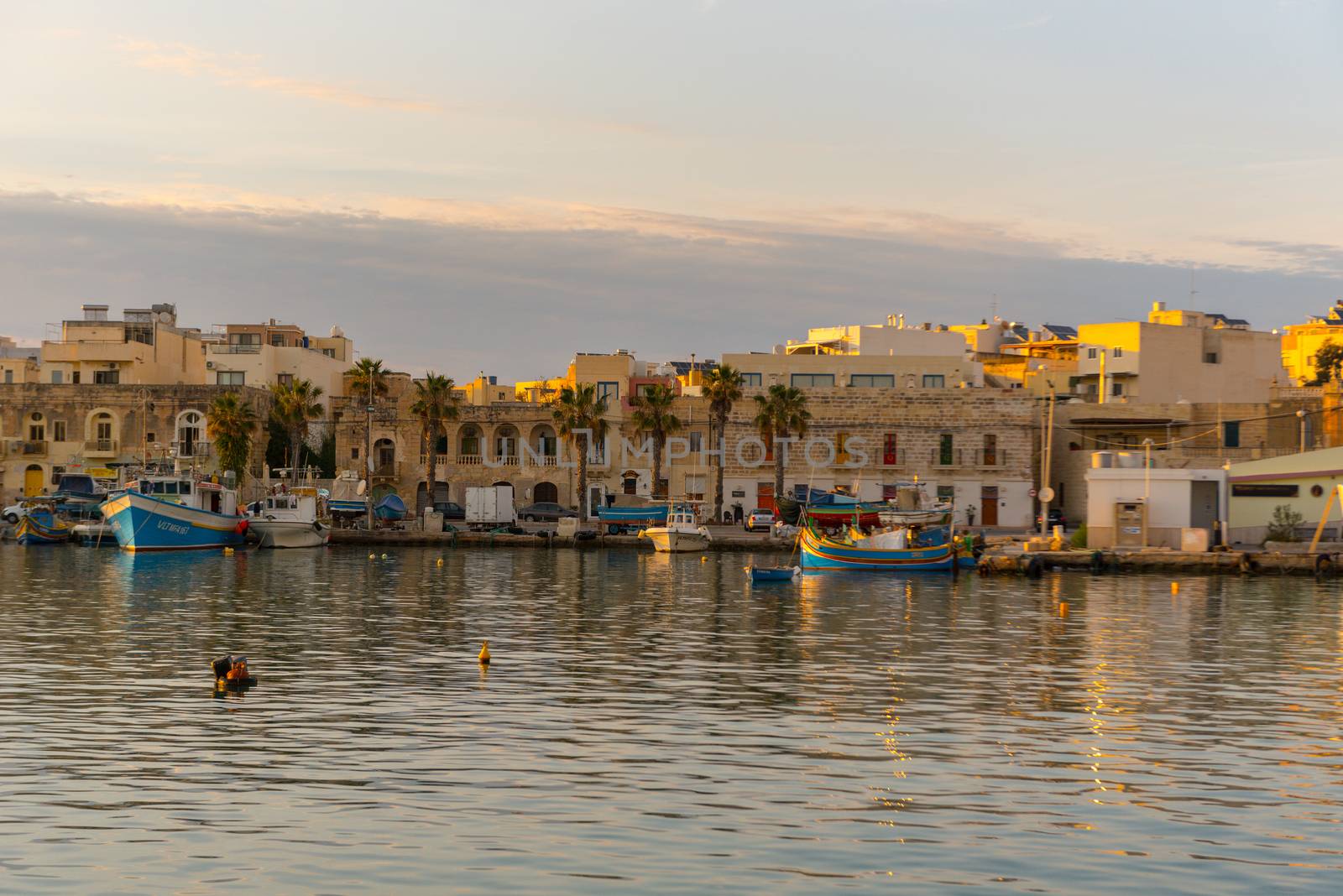 Traditional eyed colorful boats Luzzu in the Harbor of Mediterranean fishing village Marsaxlokk, Malta