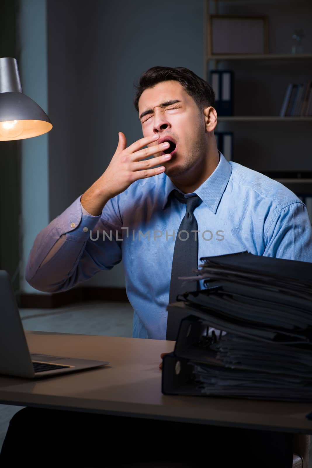 Employee working late at night at important report