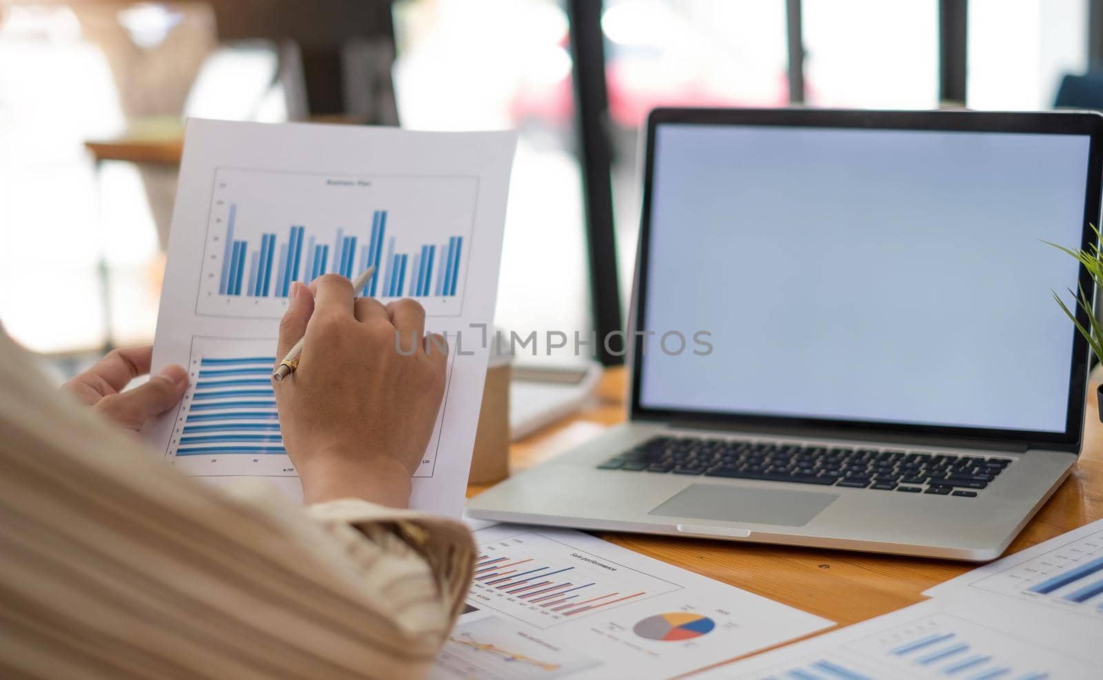 close up salesman employee hand using stylus pen to pointing on tablet screen to show company profit monthly in the meeting event at conference room , business strategy concept by wichayada