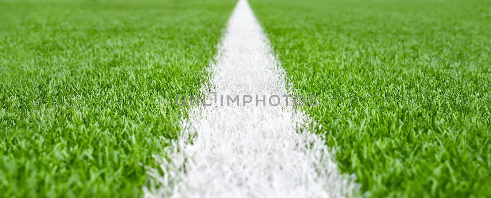 Close up soccer field lines. Background soccer pitch grass football stadium ground view. Stadium field ground grass detail. Ground football field grass macro. Design soccer stadium grass football line