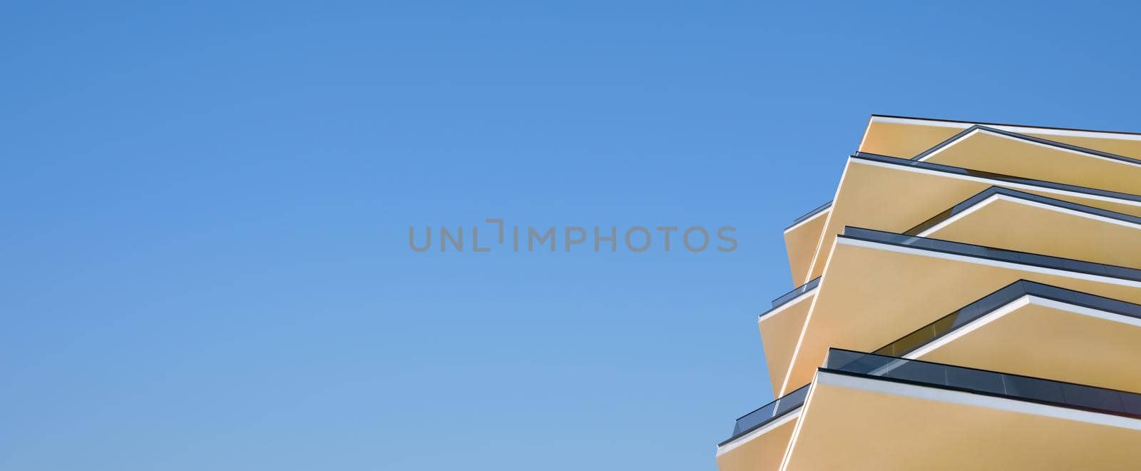 Modern architecture building detail architecture facade glass and concrete a clear blue sky banner property market. New apartments building facade hotel architecture banner real estate design elements by synel