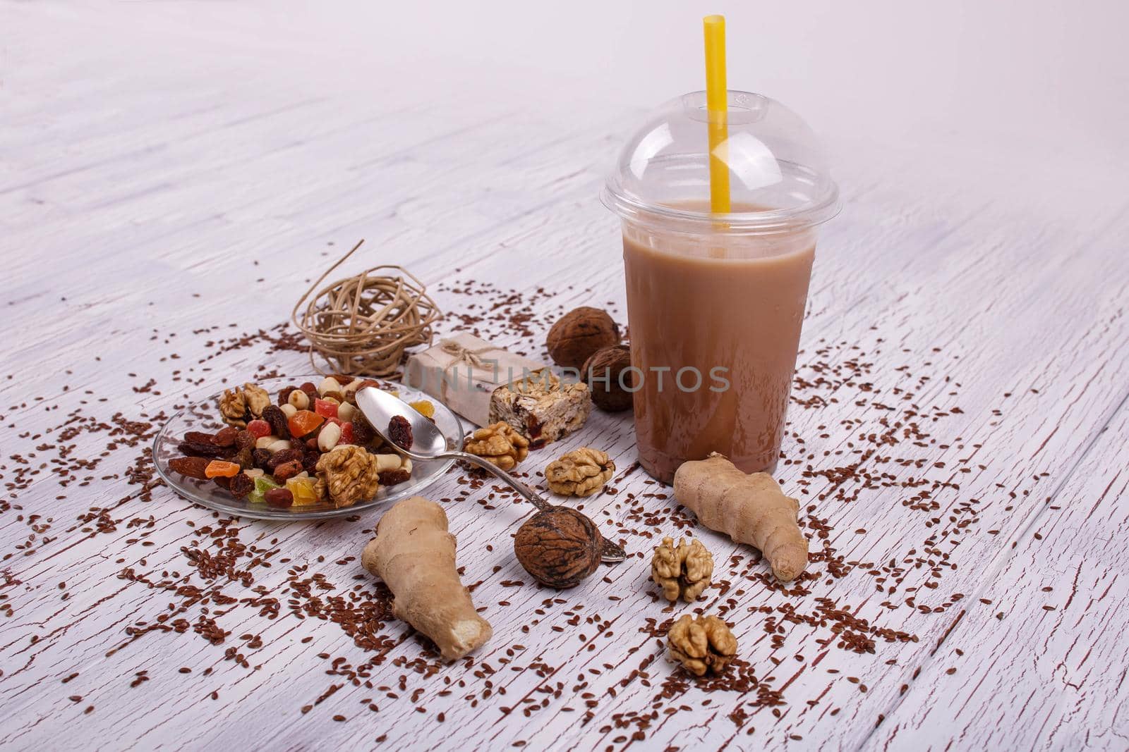 healthy brown smoothie with walnut and candied fruits lie on the table