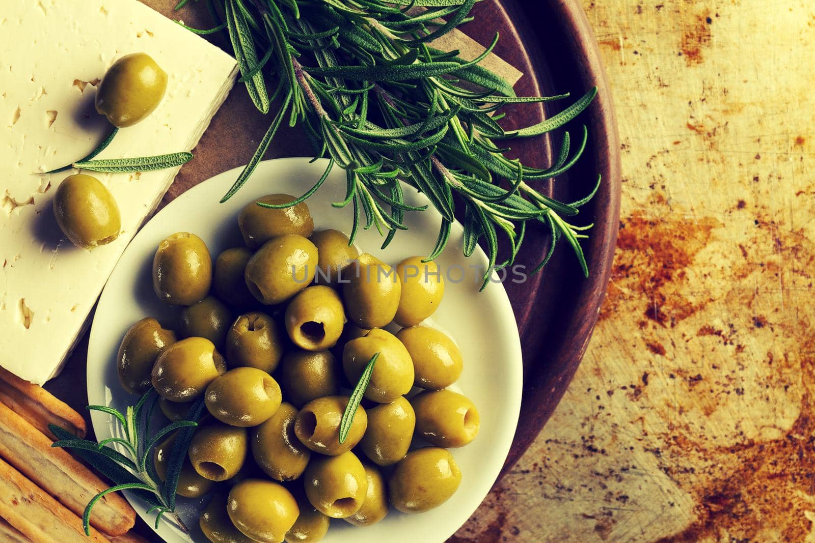 Fresh tasty greek green olives with cheese feta or goat cheese. Closeup. Mediterranean food.Toning.