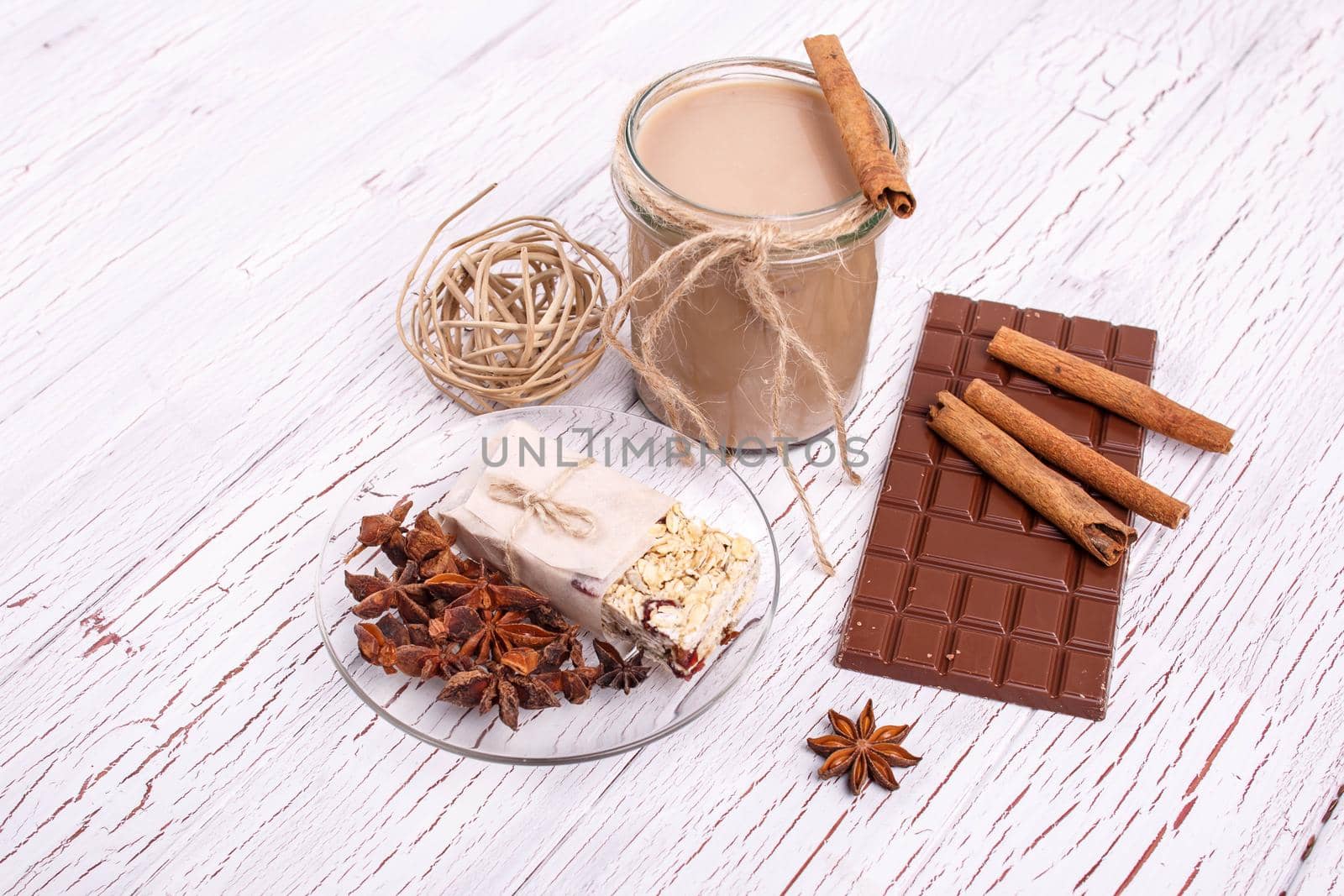 brown detox coctail with cinnamon sticks and chocolate lie on the table