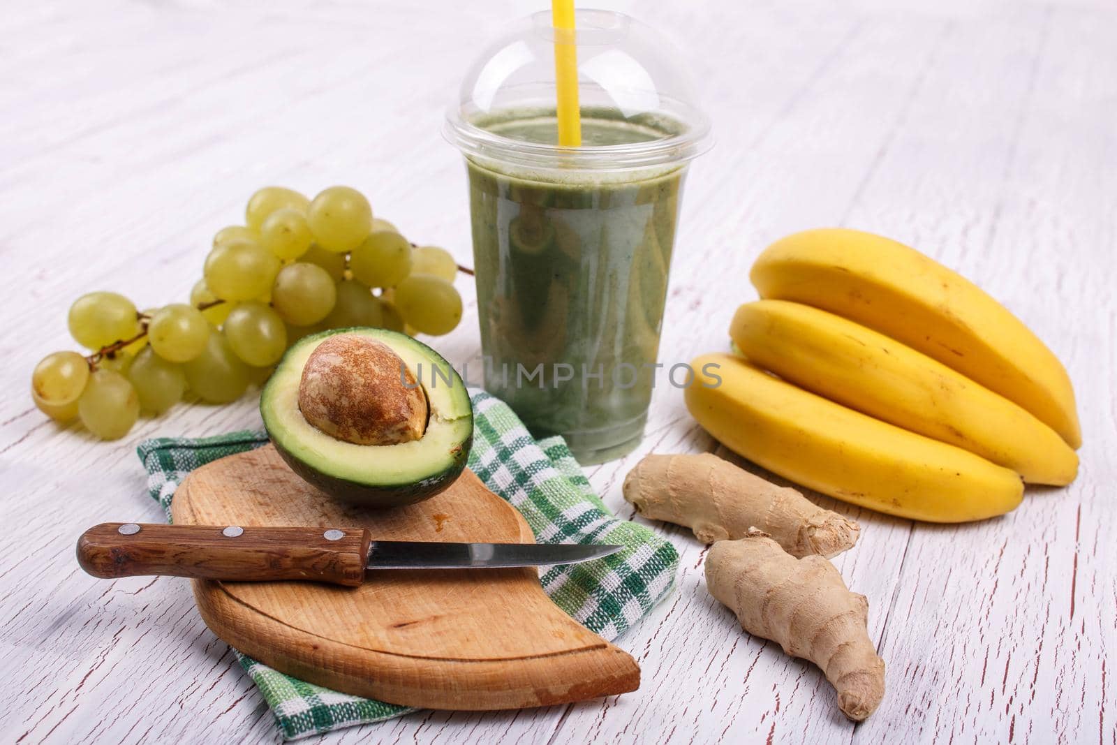 green smoothie with bananas,lime,grape and avocado lie on the table