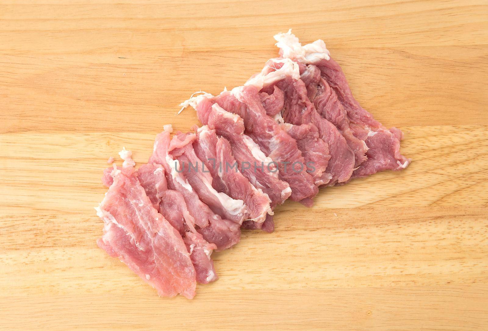 slice pork on wood board
