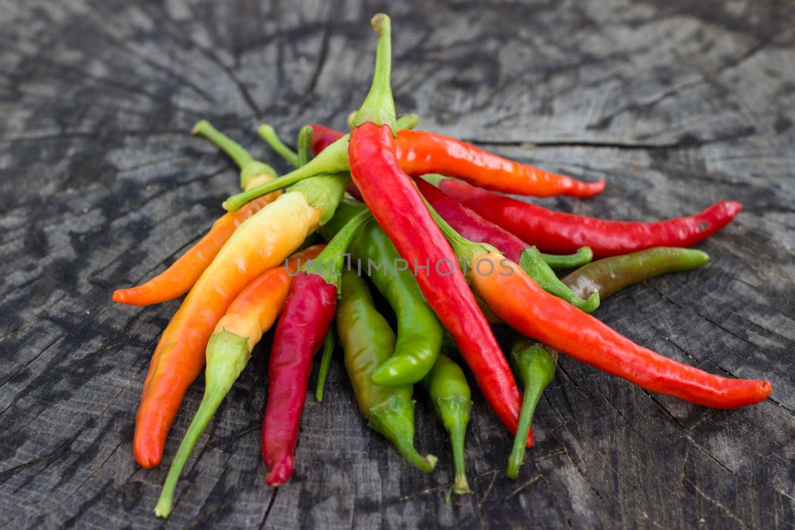 Chili peppers on wooden background.