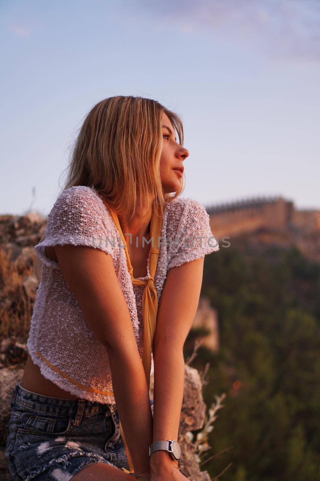 Beautiful girl at sunset. Ancient castle on the background. Alania Turkey. Tourism concept