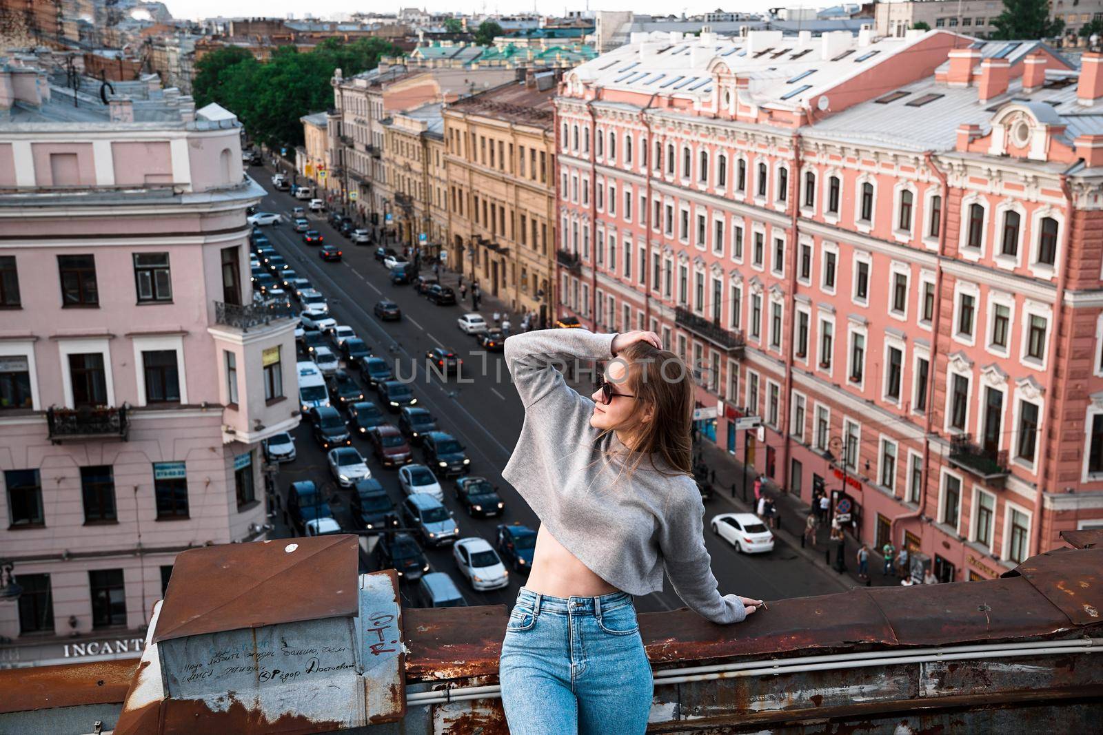 Woman is happy on the roof of Saint Petersburg, Russia by natali_brill