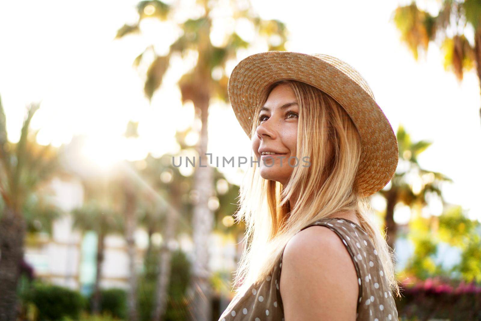 Portrait of a young blonde in a hat on a tropical background by natali_brill